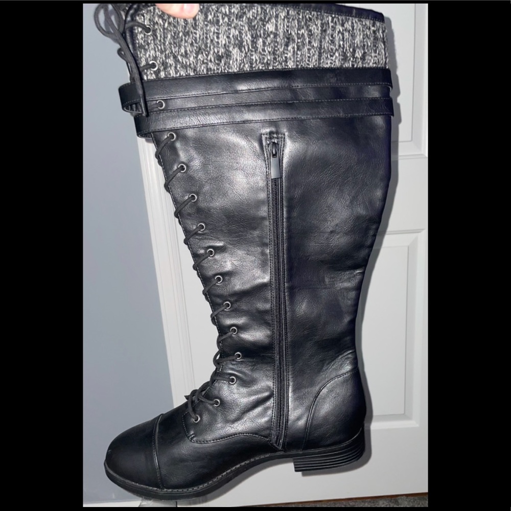 Tall black wide combat boots topped with sweater material.